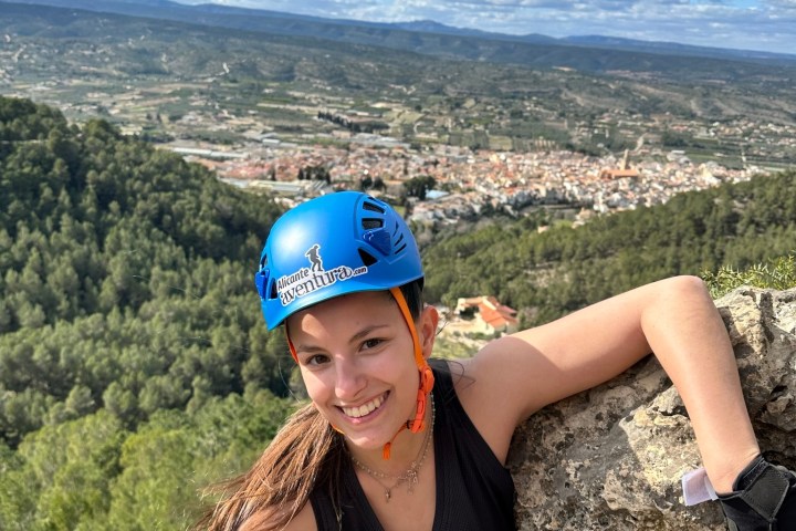a woman standing in front of a mountain