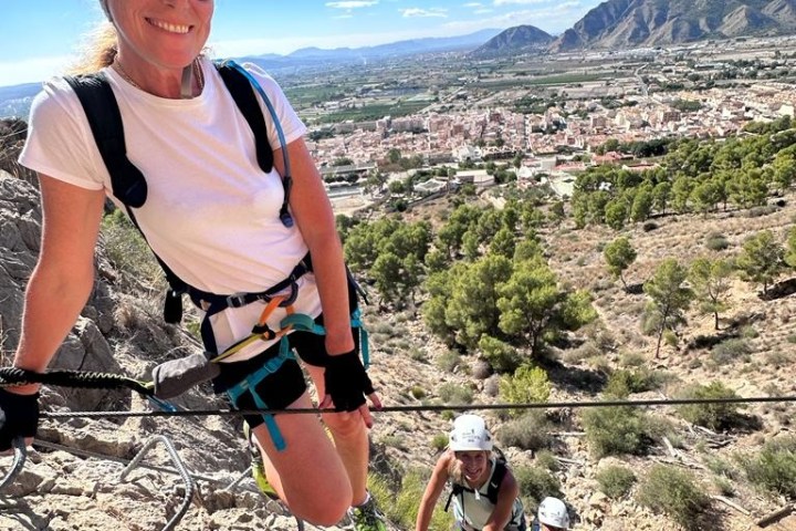 a boy standing in front of a mountain