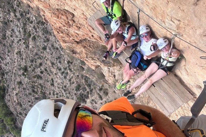 a person riding a motorcycle on the side of a mountain