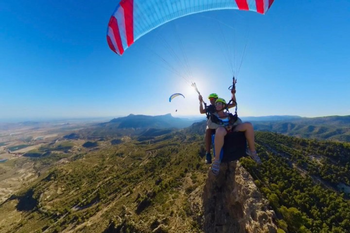 a man flying a kite high up in the air
