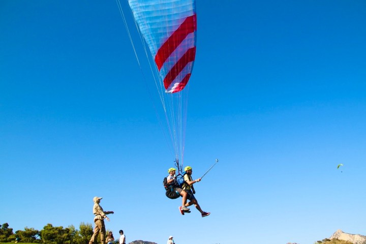 a group of people flying kites in the air