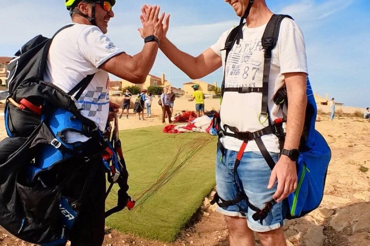 a couple of people that are standing in the grass