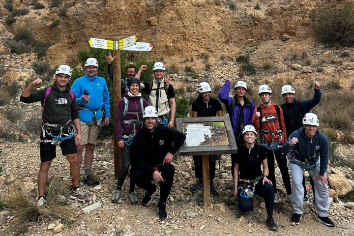a group of people standing in front of a mountain