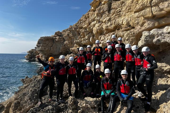 a group of people standing on top of a mountain