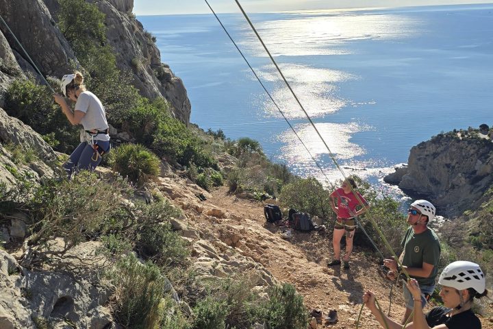 a man flying through the air on a rocky hill