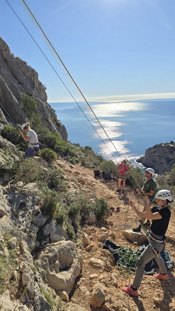 a man flying through the air on a rocky hill