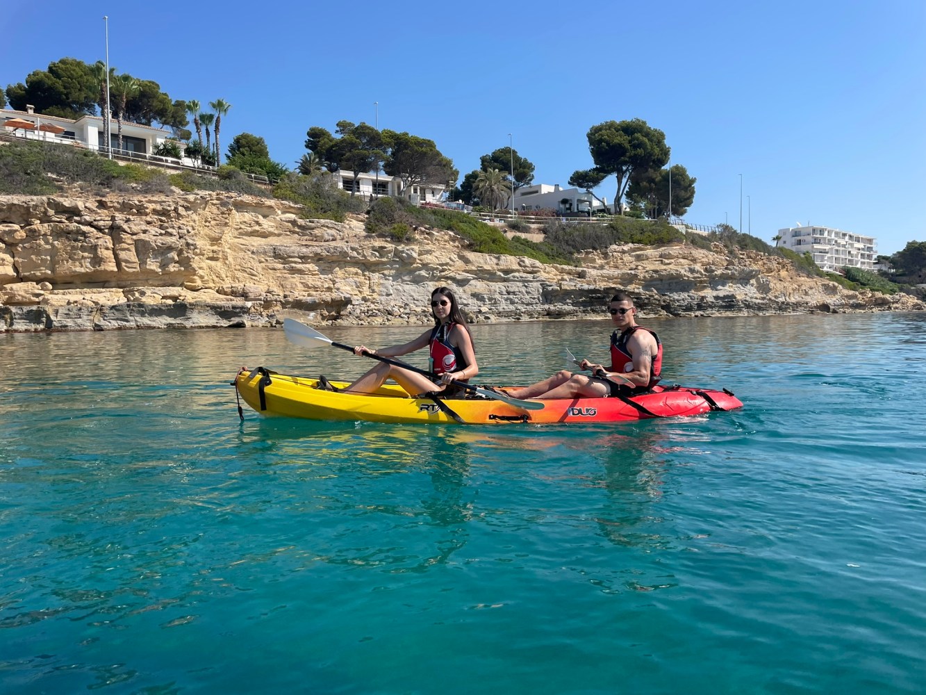 a group of people rowing a boat in the water
