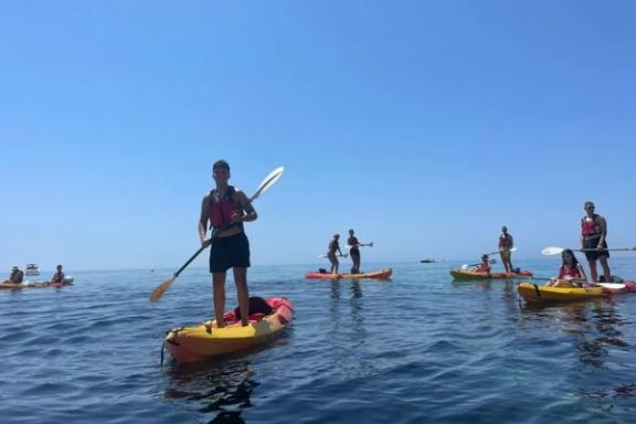 Participante disfrutando de la ruta en kayak sobre un mar en calma