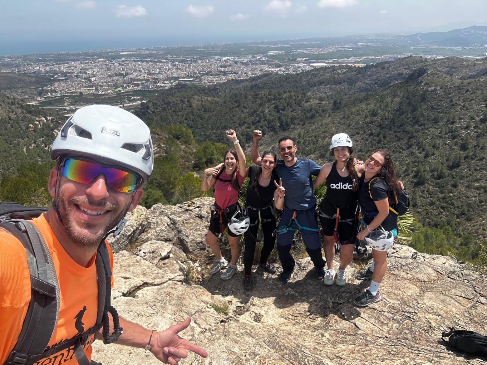 a group of people standing on top of a mountain