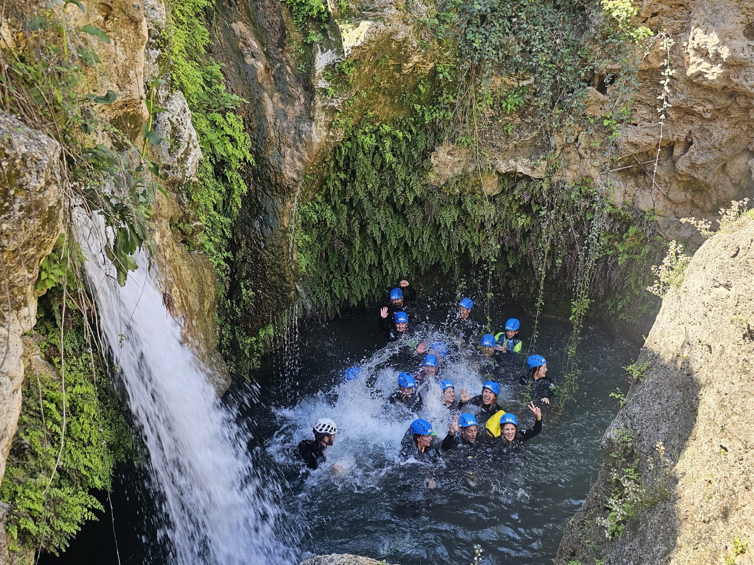a close up of a rock next to a waterfall