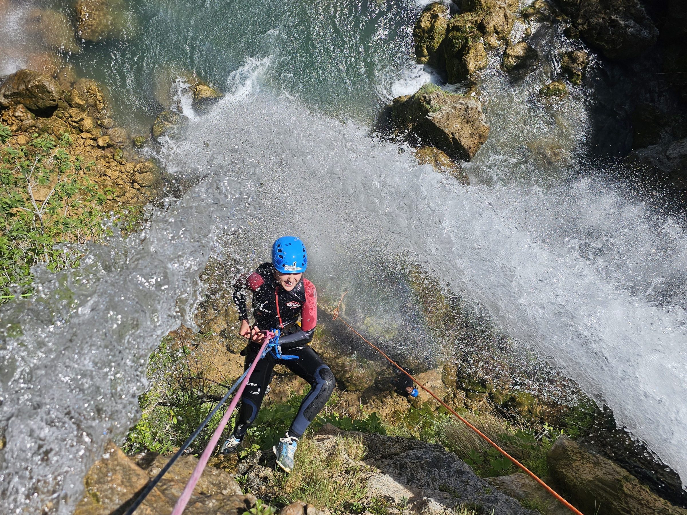 a man riding water skis on top of a rock