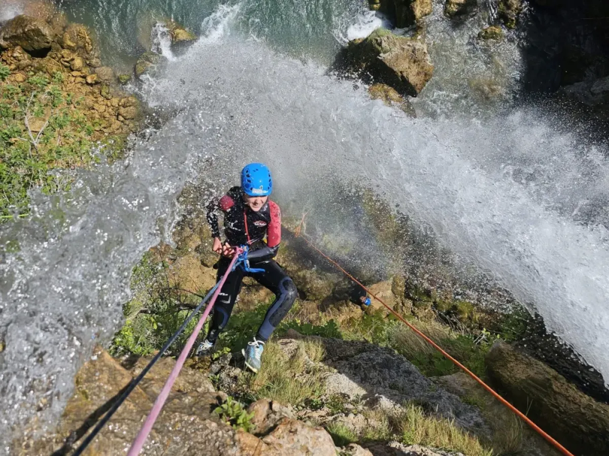 a man riding water skis on top of a rock