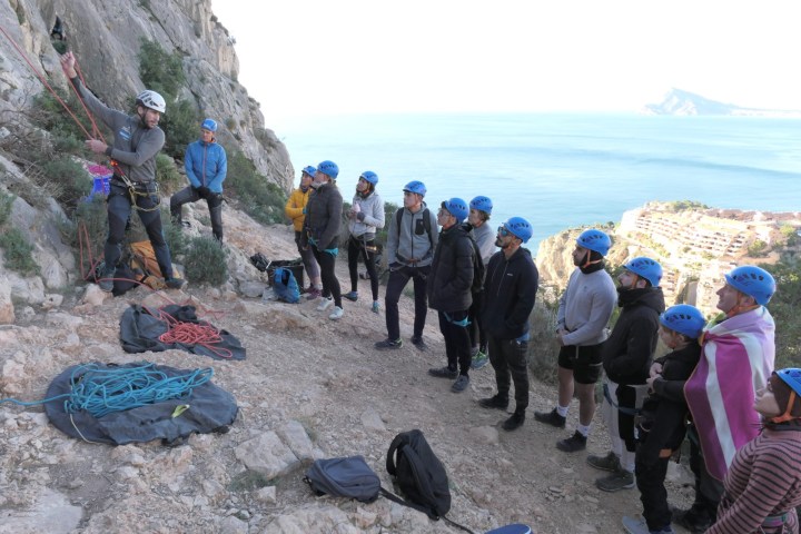 a group of people standing on a rocky beach