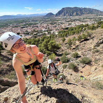 a woman standing on a rocky hill