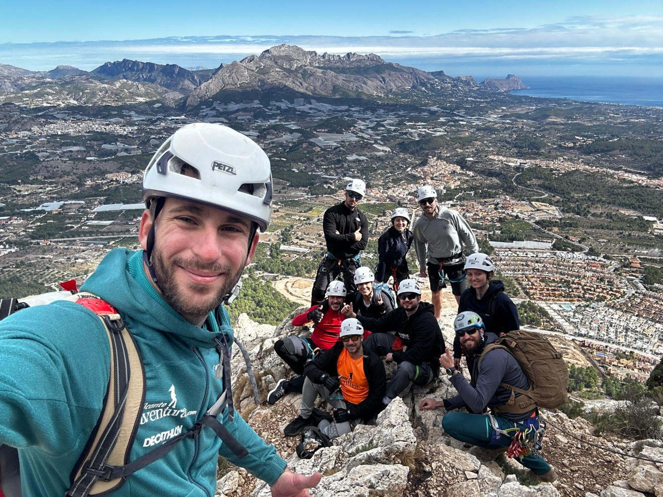 a group of people standing on top of a mountain