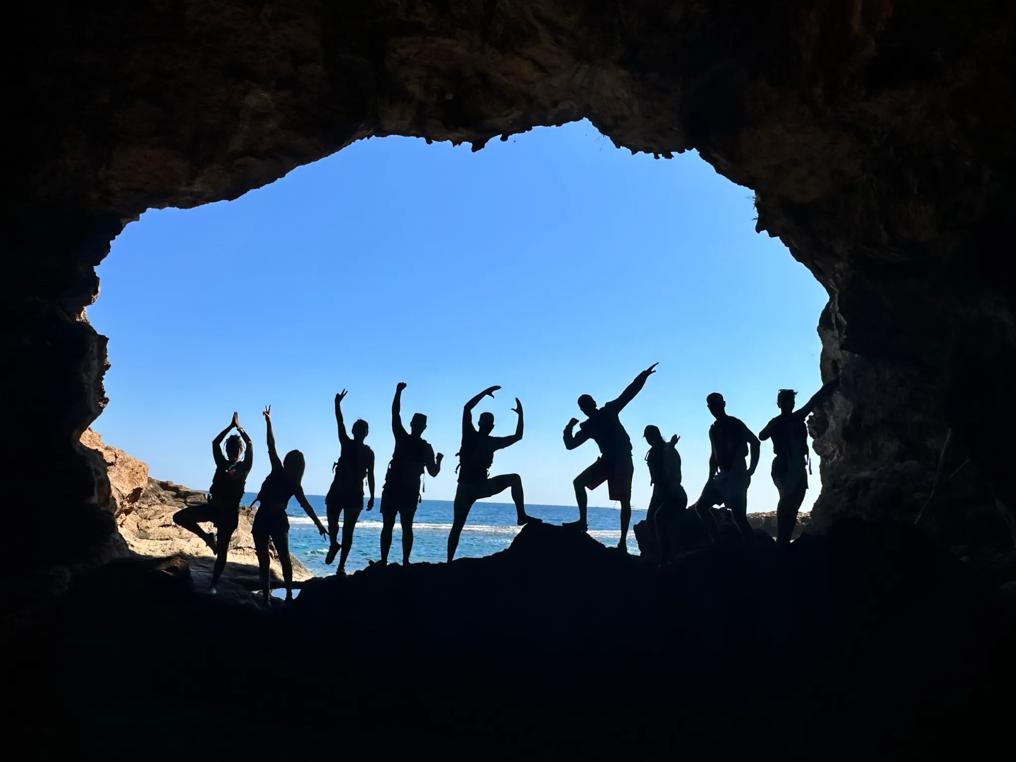 a group of people standing on top of a mountain