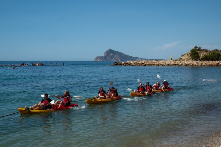 a group of people in a small boat in a body of water