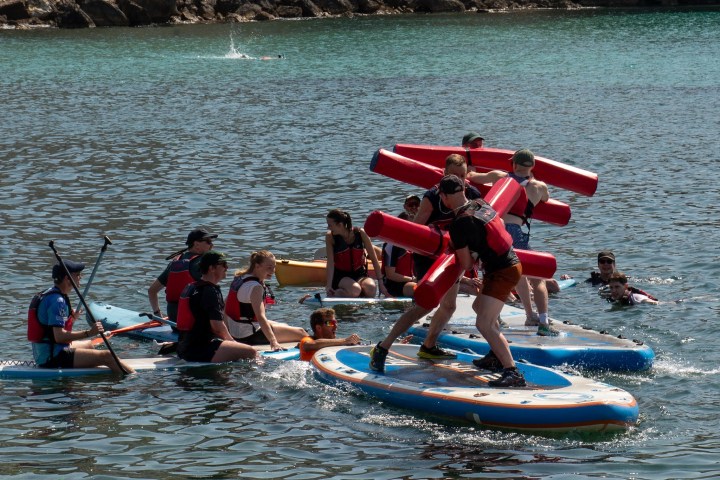 a group of people on a boat in the water