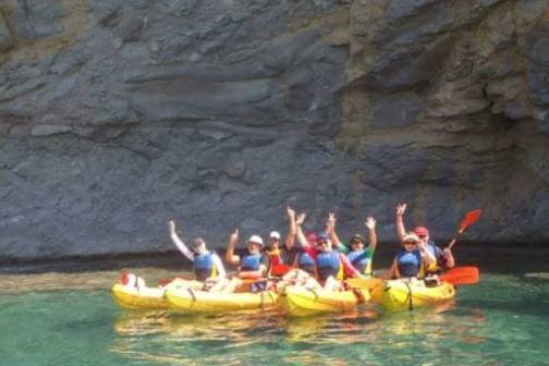 a group of people riding on the back of a boat