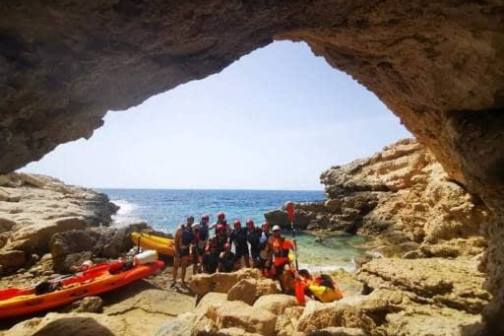 a group of people on a rocky beach