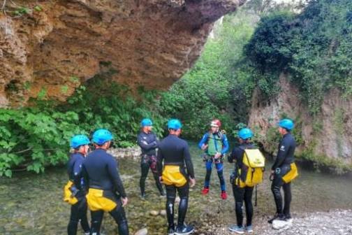 a group of people standing in front of a mountain