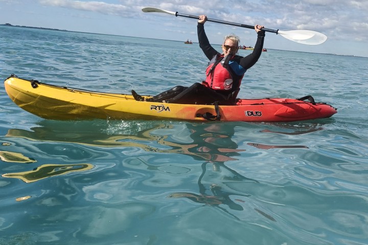 a person riding a surf board on a body of water