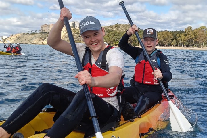a group of people riding on the back of a boat