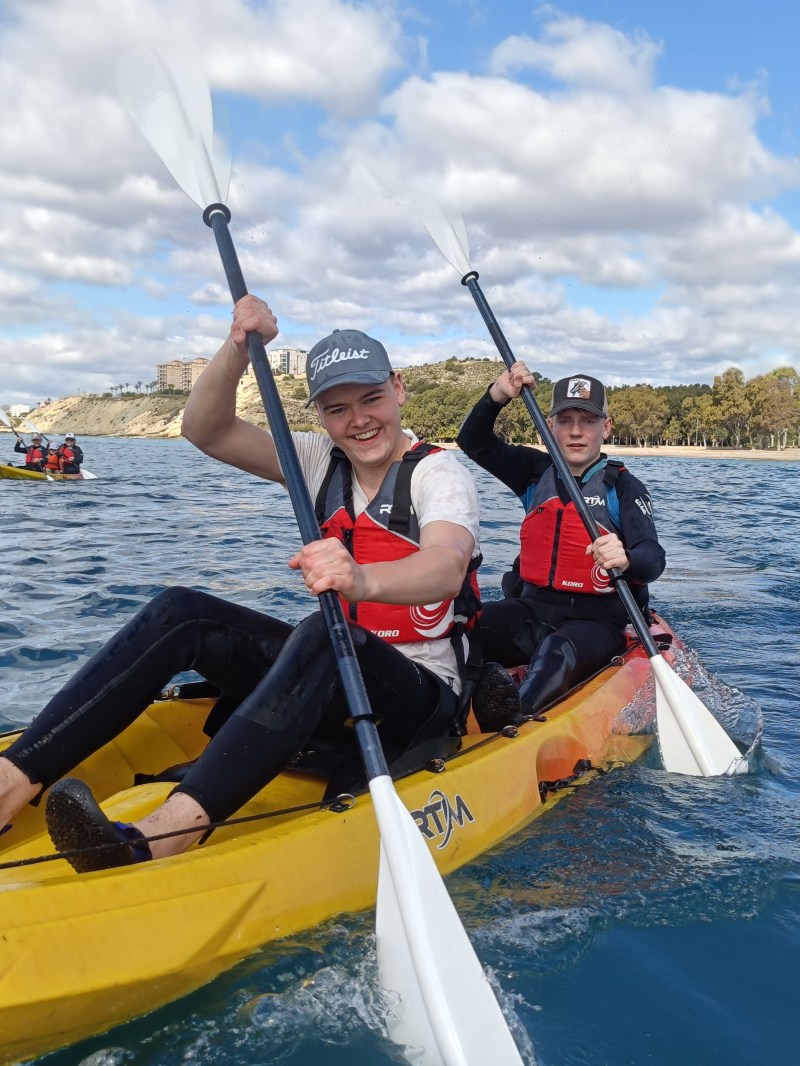 a group of people riding on the back of a boat