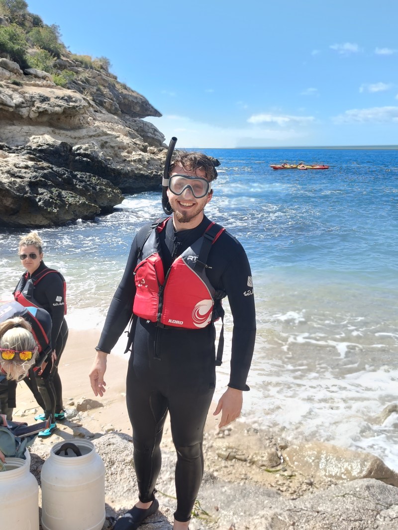 a couple of people on a rocky beach