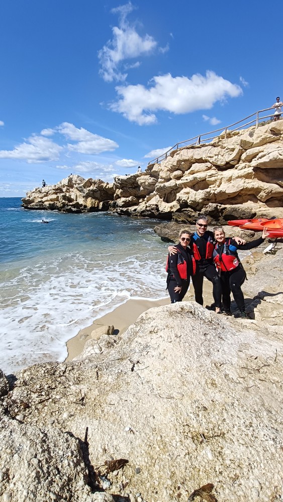 a group of people on a rocky beach