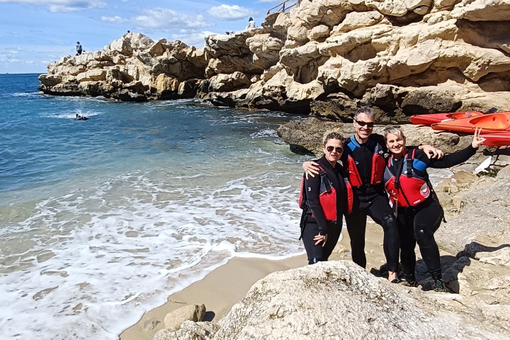a group of people on a rocky beach