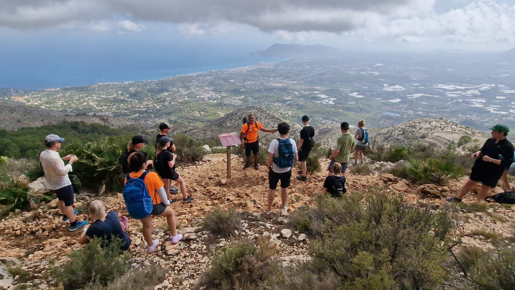 a group of people standing on top of a hill