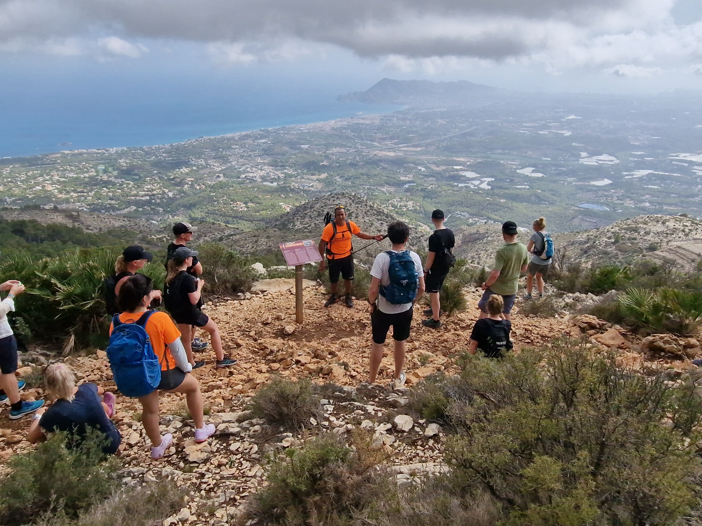 a group of people standing on top of a hill