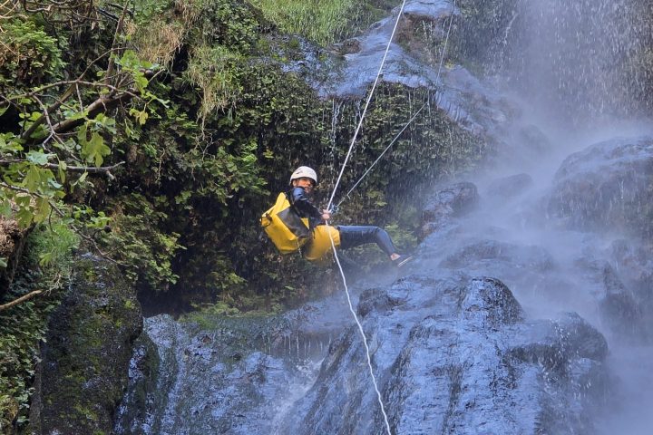 a man riding on the back of a waterfall
