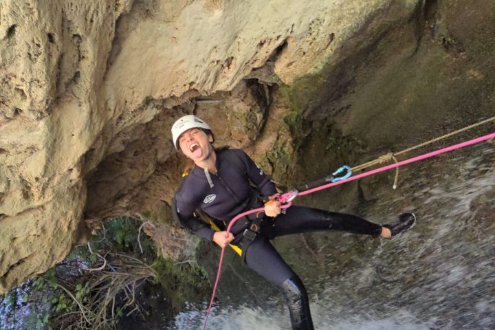 a man water skiing on a rock