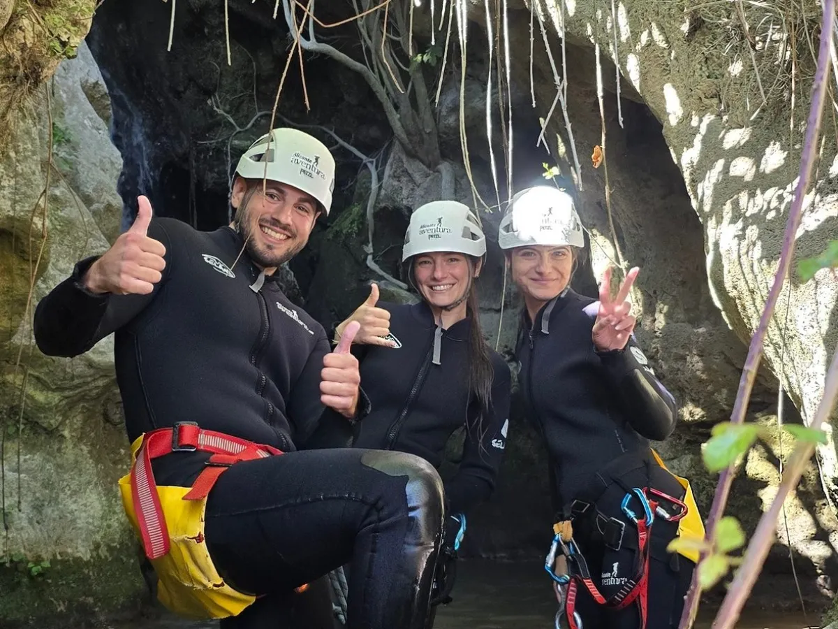 a group of people standing next to a tree