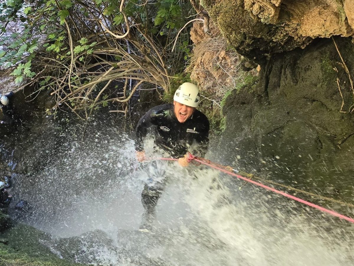 a large waterfall over some water