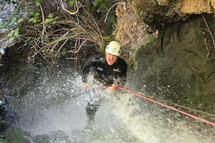 a large waterfall over some water