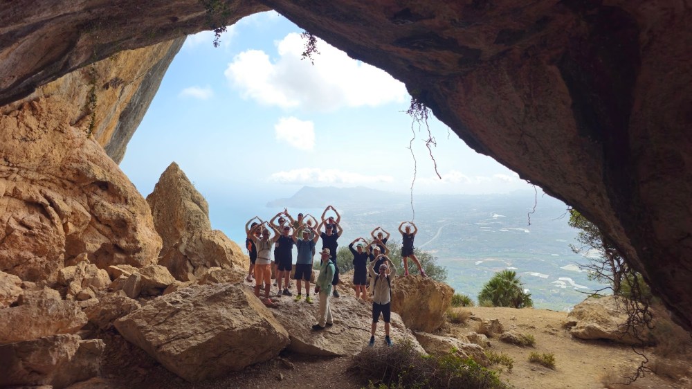 a group of people standing in a rocky area