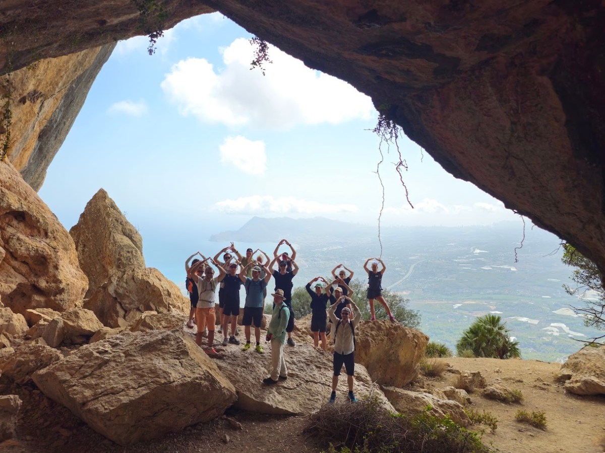 a group of people standing in a rocky area