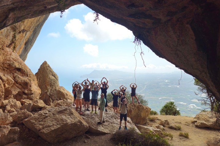 a group of people standing in a rocky area