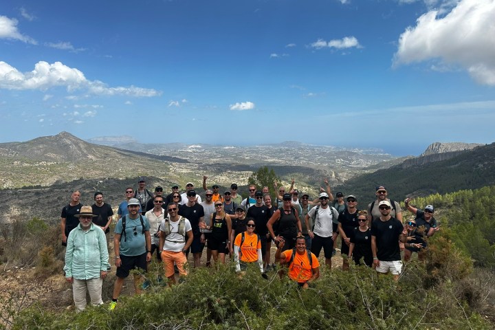 a group of people standing on top of a mountain