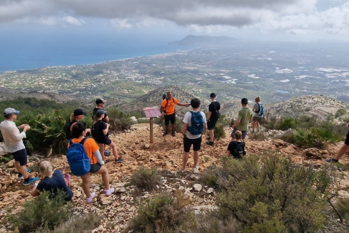 a group of people standing on top of a hill