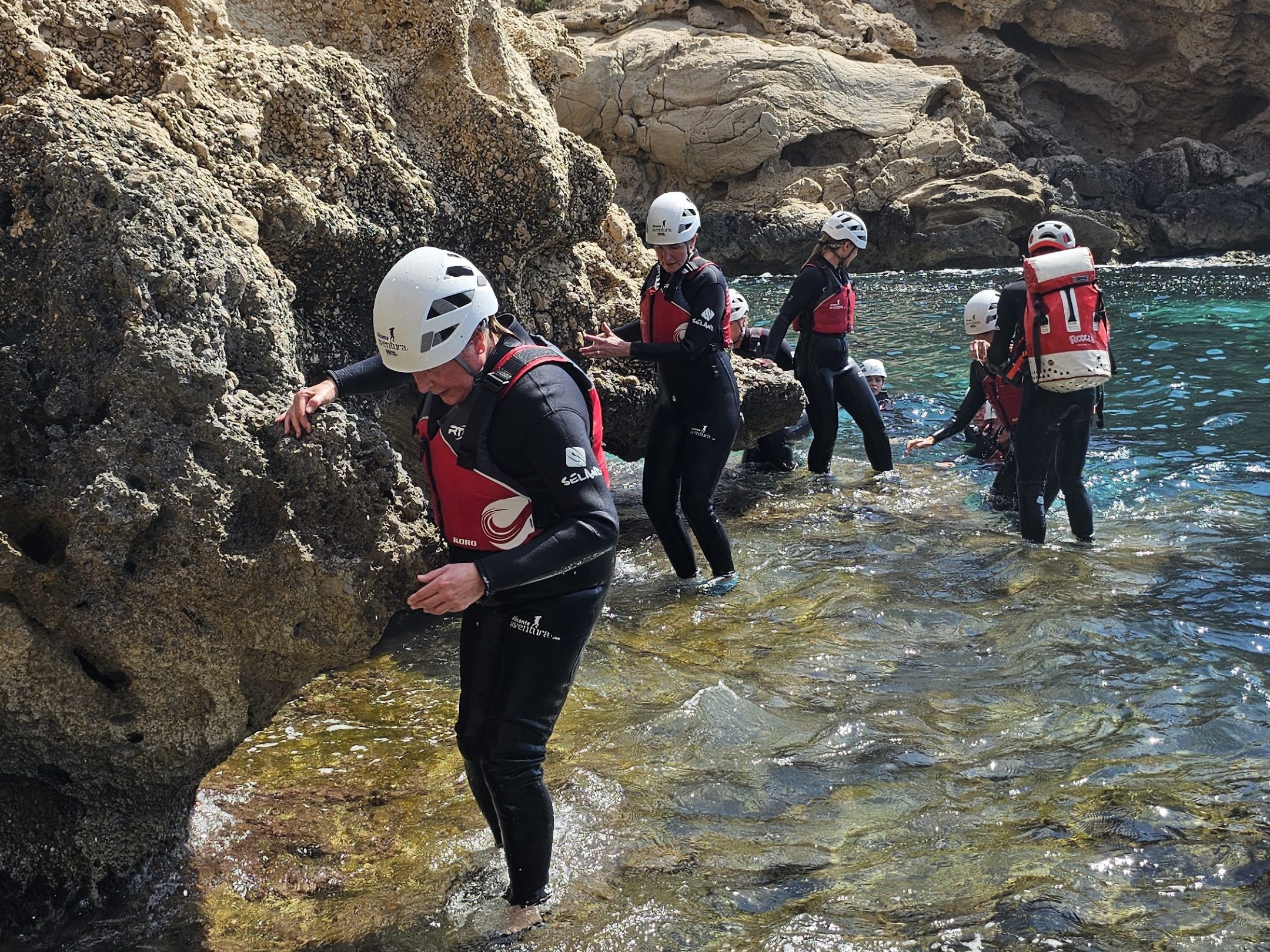 a group of people on a rocky hill