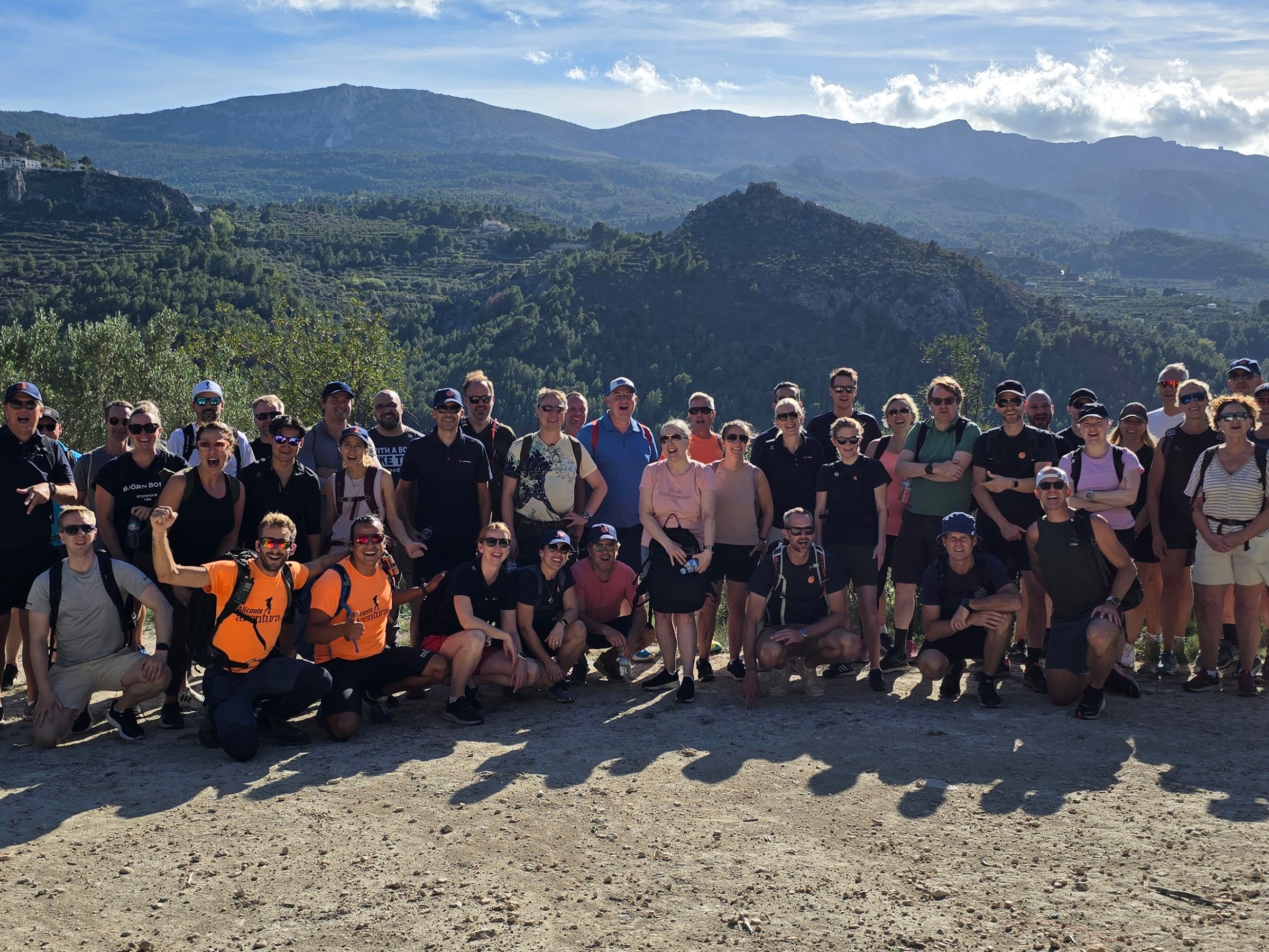 a group of people standing in front of a crowd posing for the camera