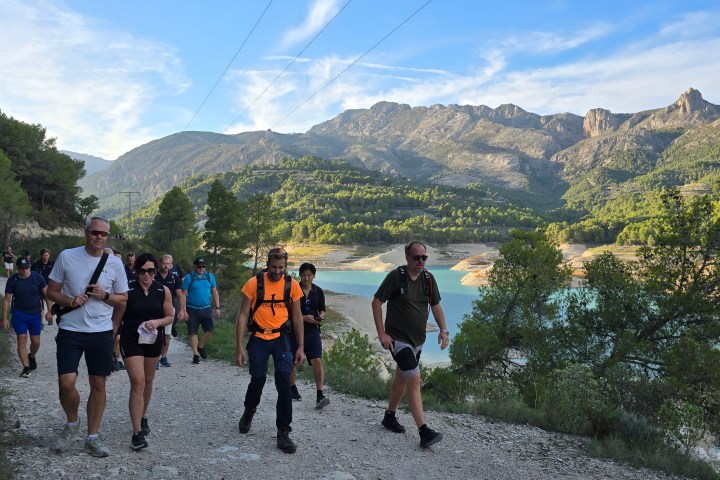 a group of people walking up a hill