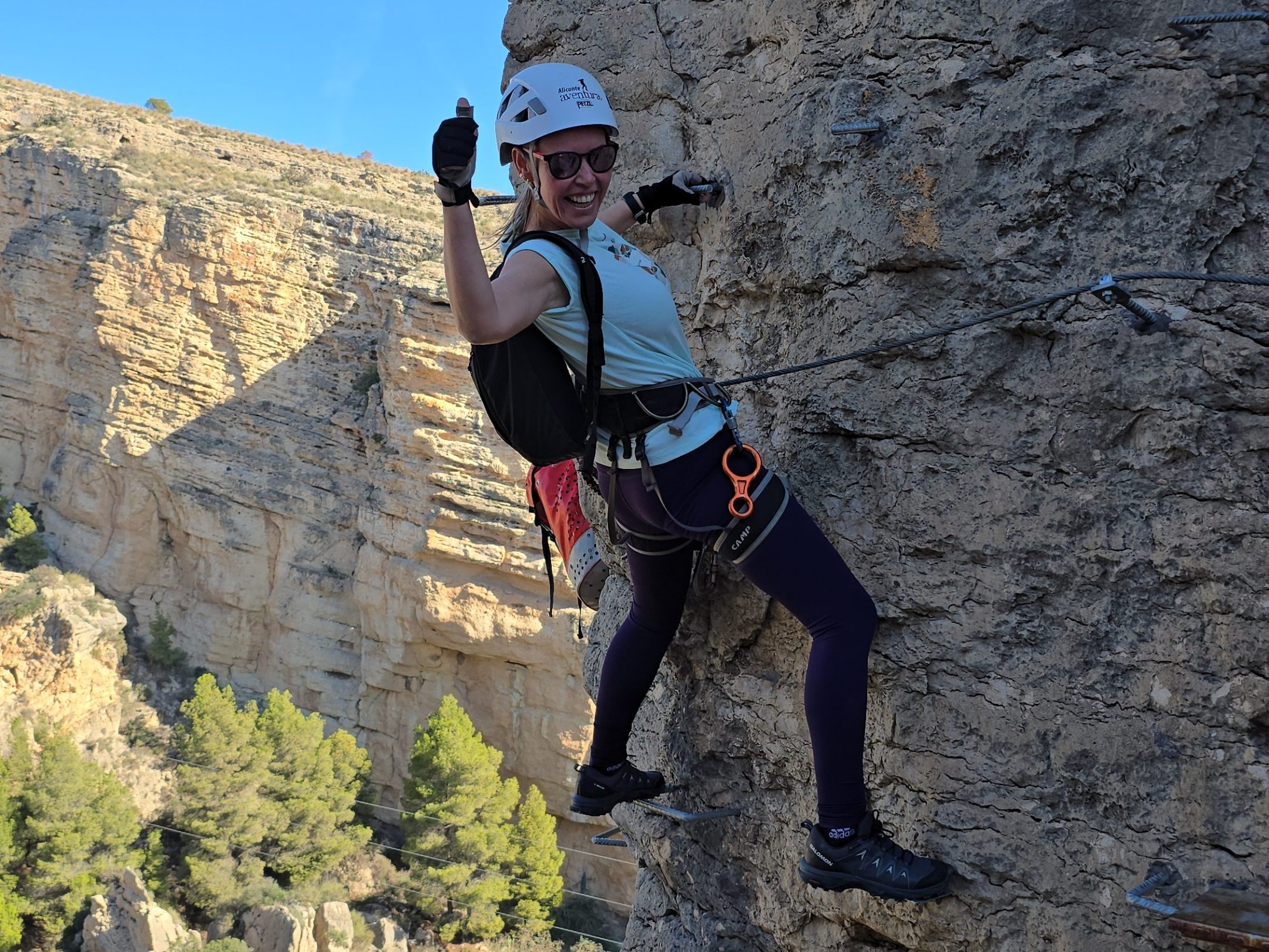 a man flying through the air on a rock