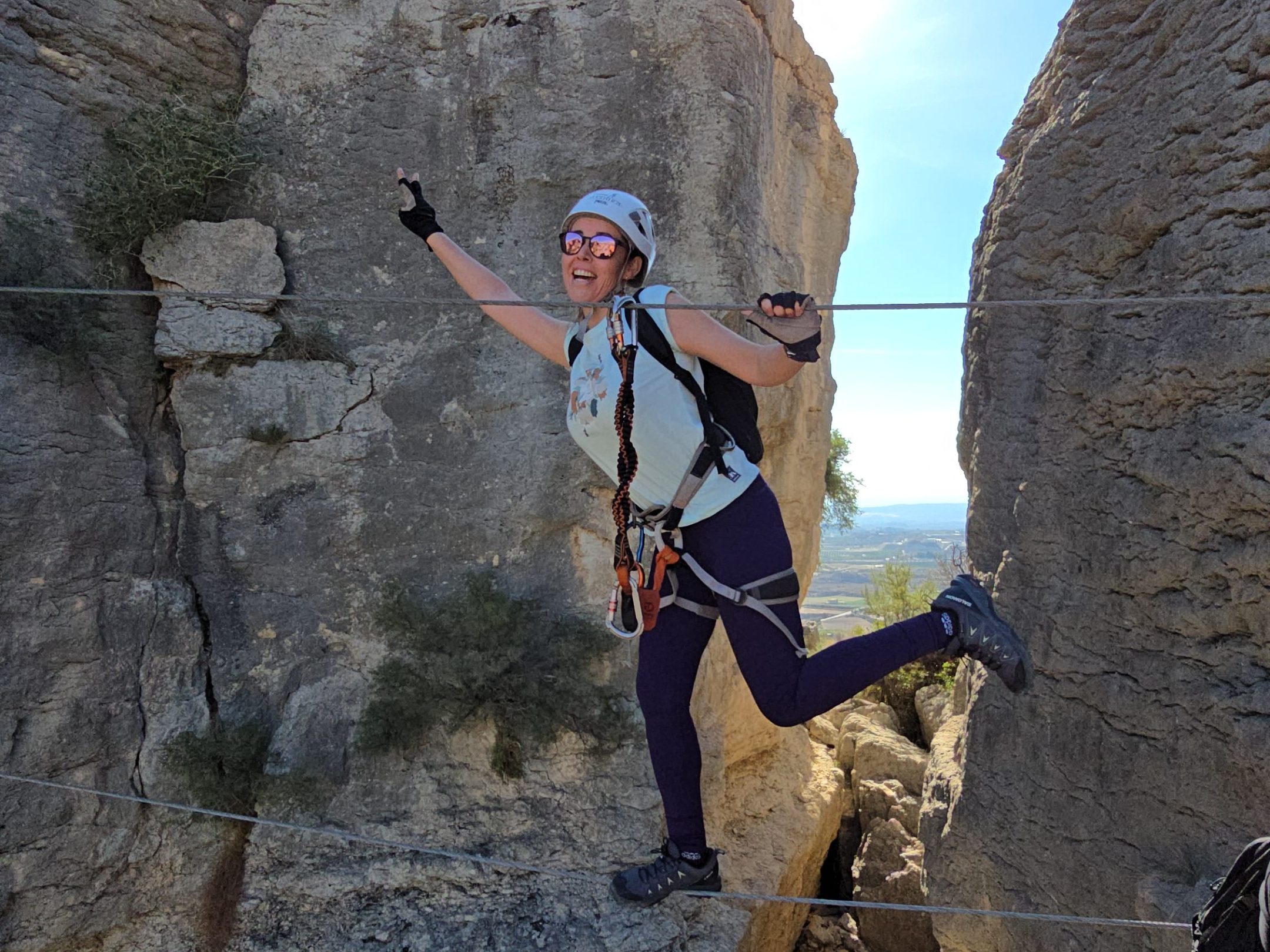 a man standing in front of a large rock