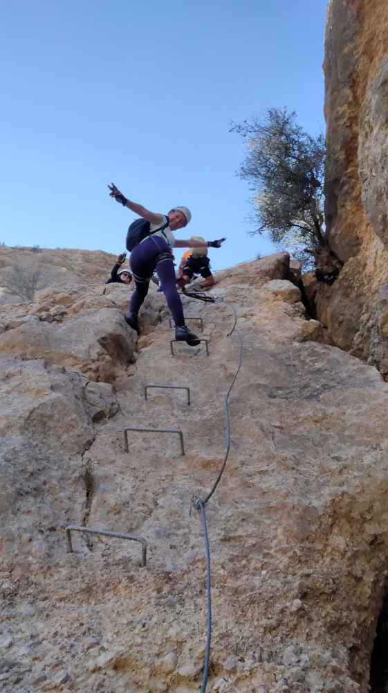 a man jumping in the air on a rock