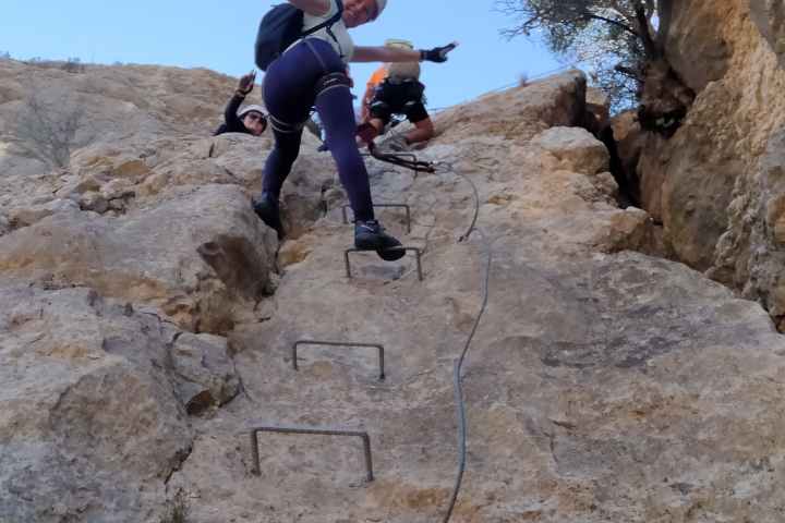 a man jumping in the air on a rock